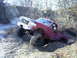 1994 Ford F-250 - This red Ford F-series truck is navigating a steep, muddy incline during an off-road excursion.