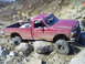 1994 Ford F-250 - This red 1994 Ford F-250 is navigating a rocky off-road course.