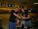 1994 Ford F-250 - Two men celebrate in a bowling alley, with bowling lanes and screens visible in the background.
