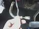 1978 Ford Bronco - A close-up view of a vehicle's interior wiring harness connection being held by a hand.