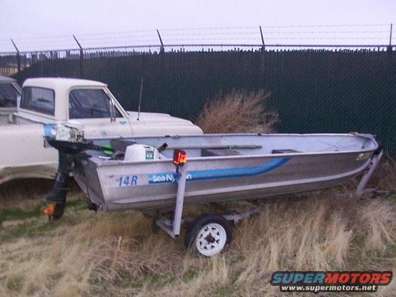 Boat on trailer next to a pickup truck