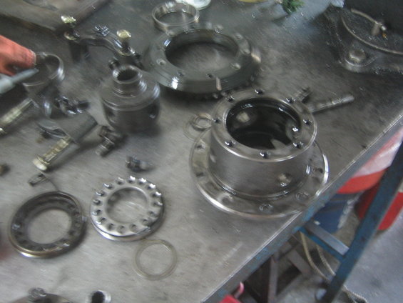 Differential components laid out on a workbench, including gears and housing