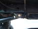 1994 Jeep YJ - Close-up view of the undercarriage of a 1994 Jeep YJ, showing frame and suspension parts.