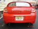 2005 Dodge SRT-4 - Rear view of a red 2005 Dodge SRT-4, showing its distinctive taillights and dual exhaust pipes.