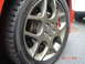2005 Dodge SRT-4 - A close-up shot focuses on a car's wheel and tire, with a portion of another vehicle visible to the right.