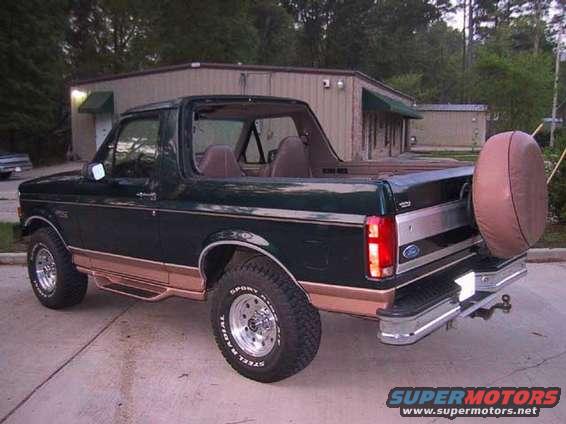 Dark green 1995 Ford Bronco with tan trim and spare tire on rear