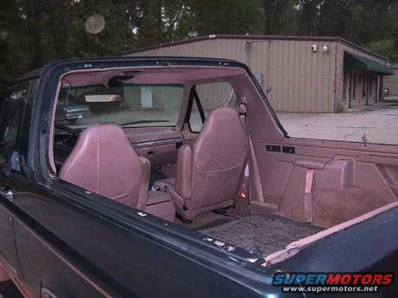 1995 Ford Bronco interior showing front bucket seats and rear bench seat area