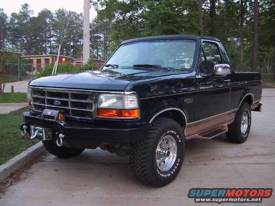 Dark green 1995 Ford Bronco with aftermarket bumper and winch, 3/4 front view