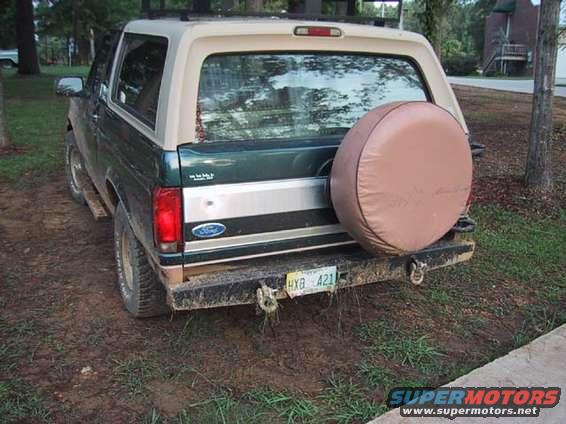 1995 Ford Bronco rear view, green and tan with spare tire cover