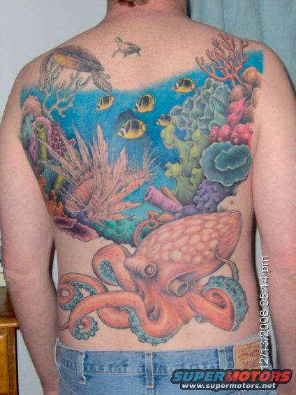 Tattoo of an octopus, lionfish, sea turtle, and fish on a person's back