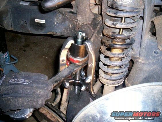 100_0486.jpg Using a big wrench under bj to help press new bj in more evenly and to prevent stud from puncturing it