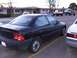 2003 Ford Ranger - A black sedan is parked in a lot with other vehicles visible in the background.