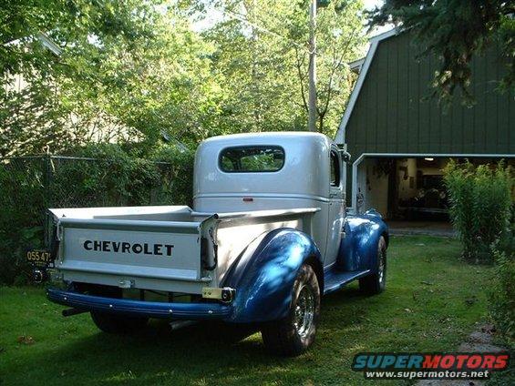 Rear view of a 1946 Chevrolet pickup truck with a blue lower body and silver cab