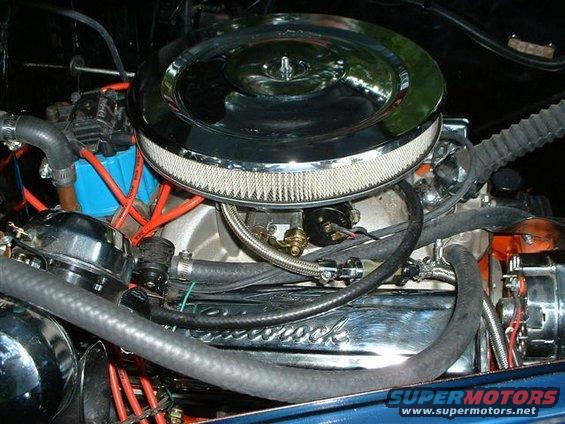 Engine bay with chrome air cleaner and valve cover reading 'Edelbrock'
