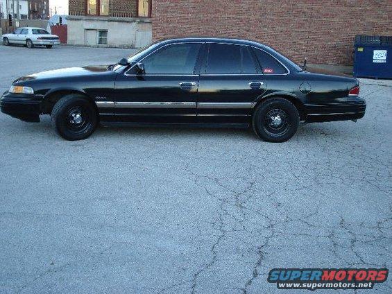 Black 1992 Ford Crown Victoria sedan, side view, with tinted windows and chrome trim