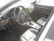 1998 BMW 7 Series - Interior shot of a car, a BMW steering wheel and wood trim accents on the dashboard and door panels.