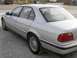 1998 BMW 7 Series - Silver sedan parked on a gravel lot, viewed from the rear passenger side.