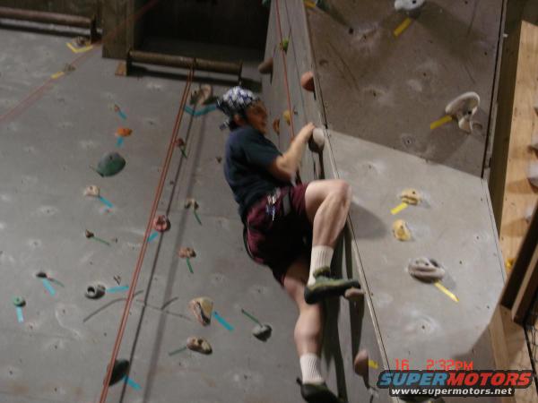 Indoor climbing wall with climber and timestamp overlay
