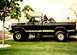 1979 Ford F-250 - This black 1979 Ford F-250 pickup truck is shown from the side, parked on a grassy lawn.