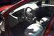 1999 Ford Taurus - The interior of a red car, showing the dashboard, steering wheel, and seats, with "SUPERMOTORS" branding visible.