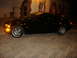 2001 BMW 3 Series - Side view of a black 2001 BMW 3 Series coupe parked on brick pavers.