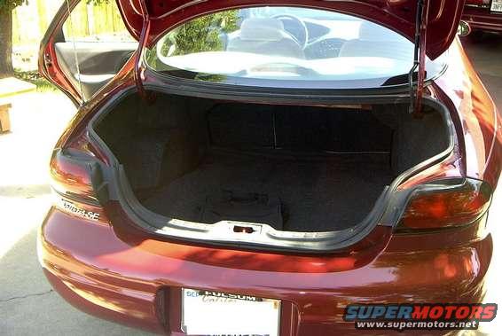 red sedan's open trunk, showing interior and rear bumper with license plate