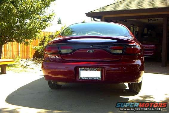 Red 1999 Ford Taurus sedan, rear view, parked in driveway