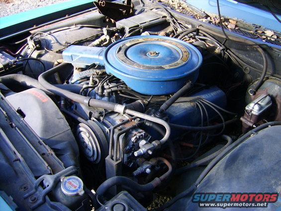 Blue engine bay with air cleaner and hoses visible