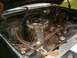 1986 Ford Bronco - The engine bay of a vehicle shows various components including the air cleaner assembly and radiator.