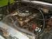 1986 Ford Bronco - The engine bay of a vehicle shows various components and hoses, with visible signs of wear and staining.