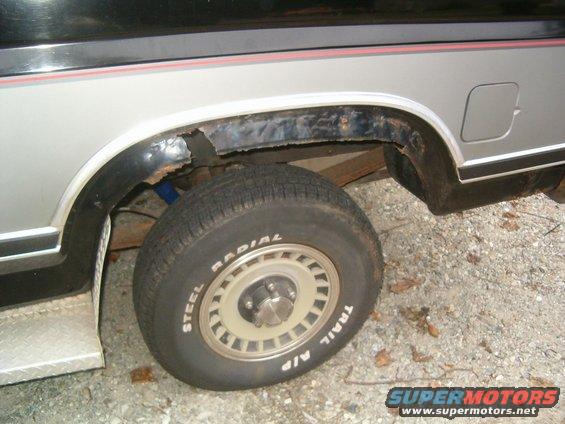 close-up of rusted wheel well and tire on a vehicle