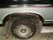 1986 Ford Bronco - The rear wheel well of a 1986 Ford Bronco shows significant rust damage.