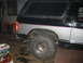 1986 Ford Bronco - This Ford Bronco is undergoing some work in a garage setting, with its rear brake light on.