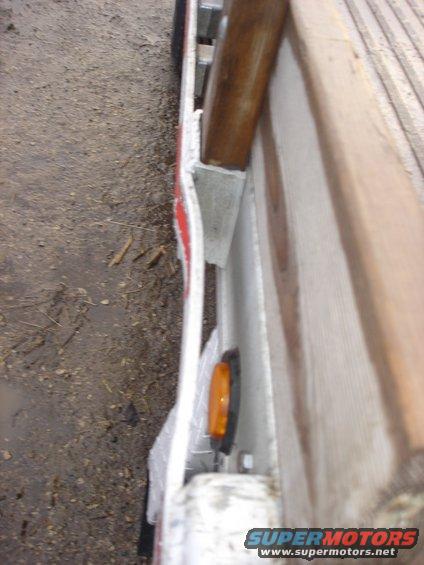 Close-up of a trailer's amber side marker light and metal frame