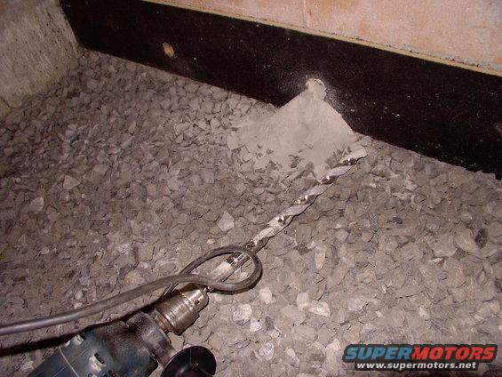 Two 3/4" holes drilled into the 10" poured basement wall nearly wasted the old hammer drill, but they're necessary to pass the PEX in and out. Note the black joe glued onto the walls for thermal separation to allow expansion.