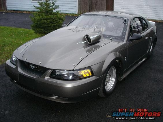 Gray custom Mustang with hood scoop and drag racing tires