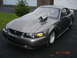 1990 Ford Mustang - This heavily modified Mustang features a prominent hood scoop and racing slicks, indicating it's built for performance.