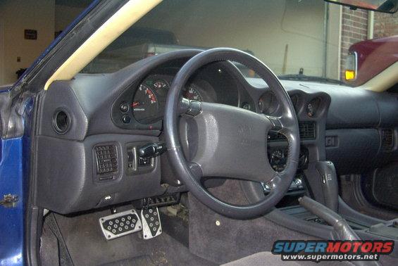 Interior of a 1994 Dodge Stealth showing dashboard, steering wheel, and pedals