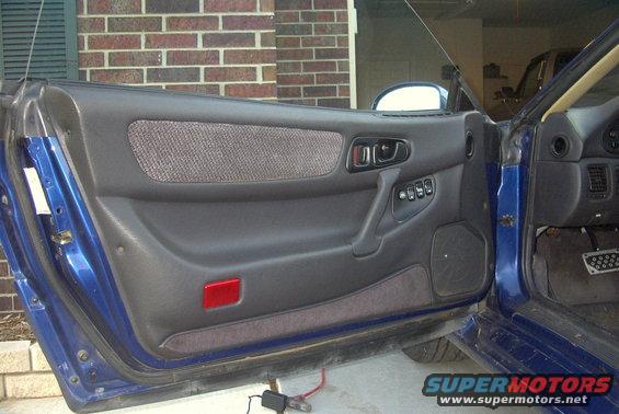 1994 Dodge Stealth interior door panel with power window controls and speaker grille