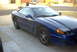 1994 Dodge Stealth - A blue 1994 Dodge Stealth coupe is parked on a driveway.