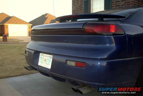 Blue 1994 Dodge Stealth rear view with spoiler and dual exhaust pipes