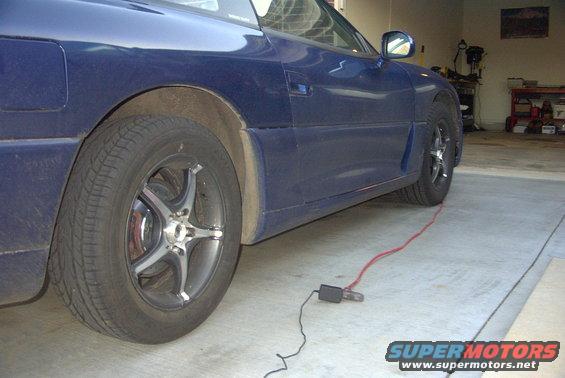 Blue 1994 Dodge Stealth parked in garage, side view showing rear wheel and door
