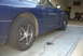 1994 Dodge Stealth - Side profile of a blue 1994 Dodge Stealth, parked indoors with a red cord running near the rear tire.