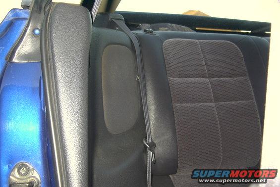 Blue car's interior showing the rear seat and seatbelt