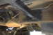1994 Ford Bronco - The underside of a vehicle reveals its frame and mechanical parts, with a visible label on the driveshaft.