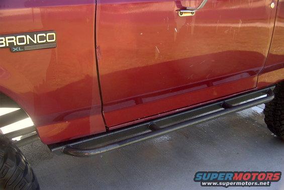 Side view of a red 1994 Ford Bronco XL showing the door and sliders