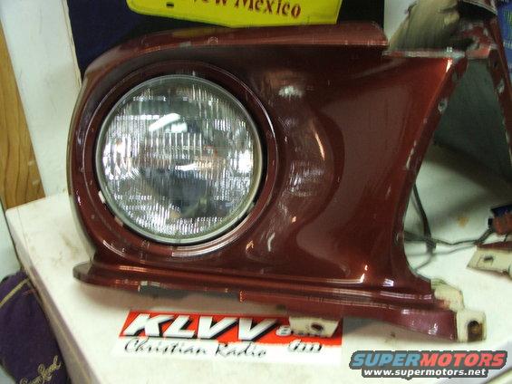 1965 Ford Mustang headlight assembly, red paint, round headlight