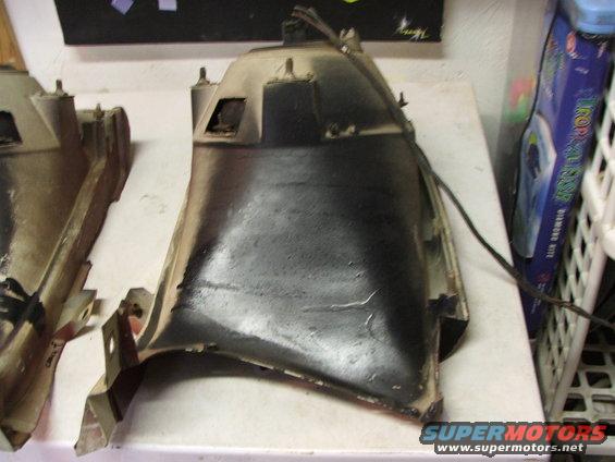 Black automotive part with mounting brackets