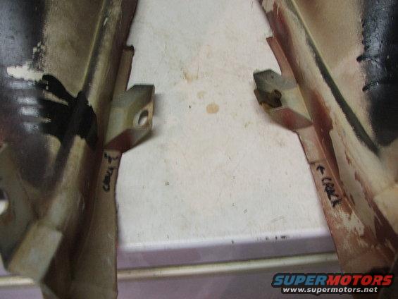 Two car parts, possibly interior trim, with handwritten labels 'CRACK T' and 'CRACK R'