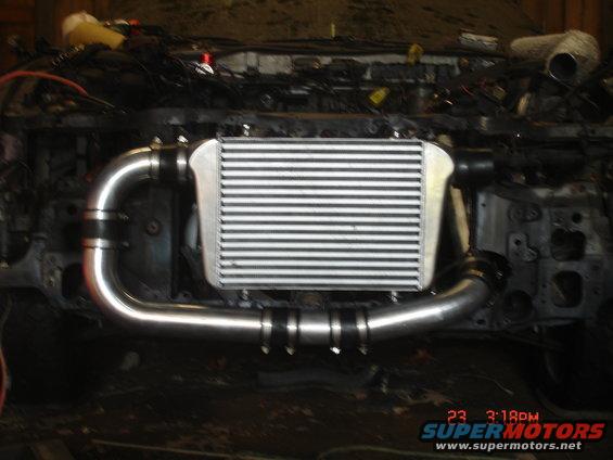 Intercooler and aluminum piping installed in a vehicle engine bay